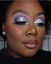 a black woman with blue and purple eye makeup