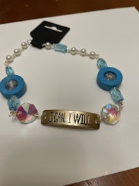 a bracelet with a blue charm and beads