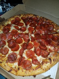 a pepperoni pizza in a cardboard box