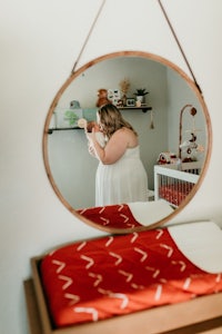 a woman is taking a picture of herself in a mirror