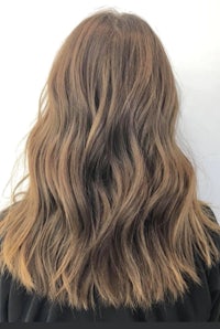 the back of a woman's hair with long wavy hair