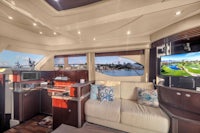 the interior of a luxury yacht with a sofa and tv