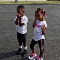 two black children standing in a parking lot