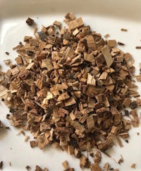a pile of wood chips on a white plate