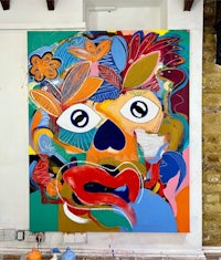 a painting of a colorful face in a studio