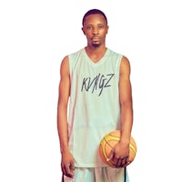 a young man holding a basketball in front of a white background