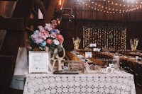 a wedding reception table in a barn