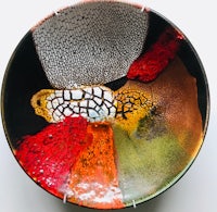 a colorful plate with a red, orange, and yellow design