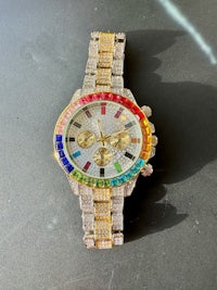 a rainbow colored watch on a table