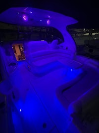 the interior of a boat is lit up with blue lights