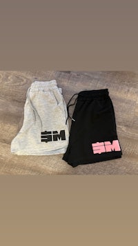 two black and pink shorts with the word ms on them
