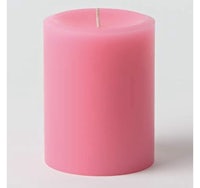 a pink candle on a white background