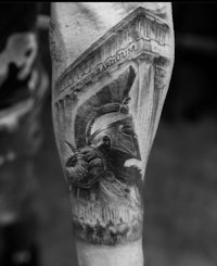 a black and white tattoo of a spartan warrior