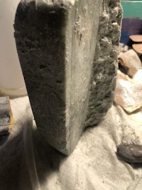 a piece of stone is sitting on top of a piece of sand