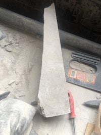 a piece of concrete is sitting on top of a piece of concrete