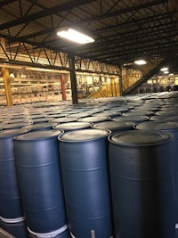 a large warehouse filled with blue barrels