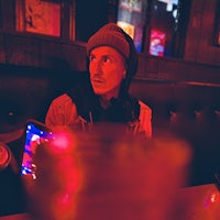 a man sitting at a table in a bar