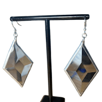 a pair of silver earrings with a diamond shape