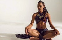 a black woman sitting in a lotus pose