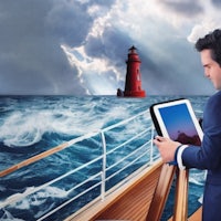 a businessman on a boat looking at a lighthouse