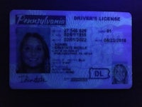 a driver's license with a purple background