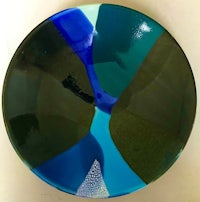 a blue and green glass plate on a white surface