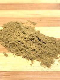a pile of cbd powder on a wooden surface