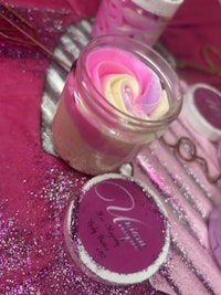 a jar of pink and white soap with glitter on top