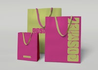 three shopping bags with the word cosmik on them