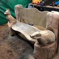 a bench made out of wood with carvings on it