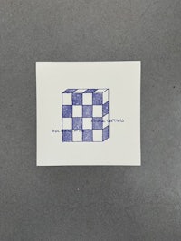 a blue and white card with a checkered pattern on it
