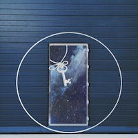 a blue door with a key and a space around it