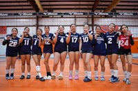 a group of volleyball players posing for a picture