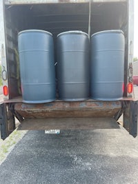 three barrels sitting in the back of a truck