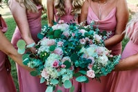 bridesmaids holding pink and green bouquets