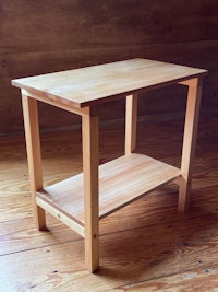 a small wooden table on a wooden floor