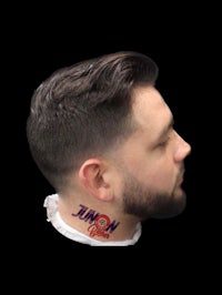 a man with a beard and a tattoo on his neck
