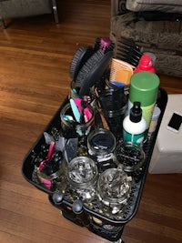 a black cart filled with hair combs and brushes