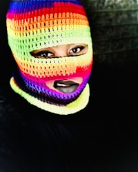 a woman wearing a colorful crocheted hat