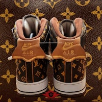 a pair of louis vuitton sneakers on a brown leather