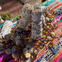 sage smudge sticks and beads on a table