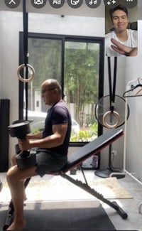 a man is using a dumbbell bench in a gym