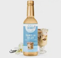 a bottle of vanilla bean ice cream next to a glass