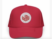 a red trucker hat with the wb logo on it