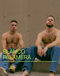 two men sitting on a concrete wall with the words blanco palmera