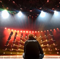 a man sitting on the floor in front of a stage