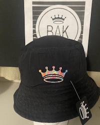 a black bucket hat with a crown on it