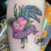 a tattoo of a t - rex with a flower and hibiscus