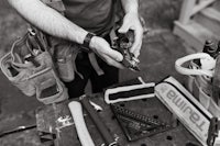 a man working with tools on a table