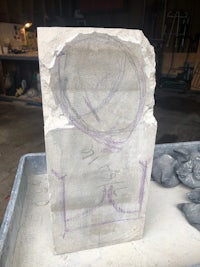 a block of stone with a drawing on it